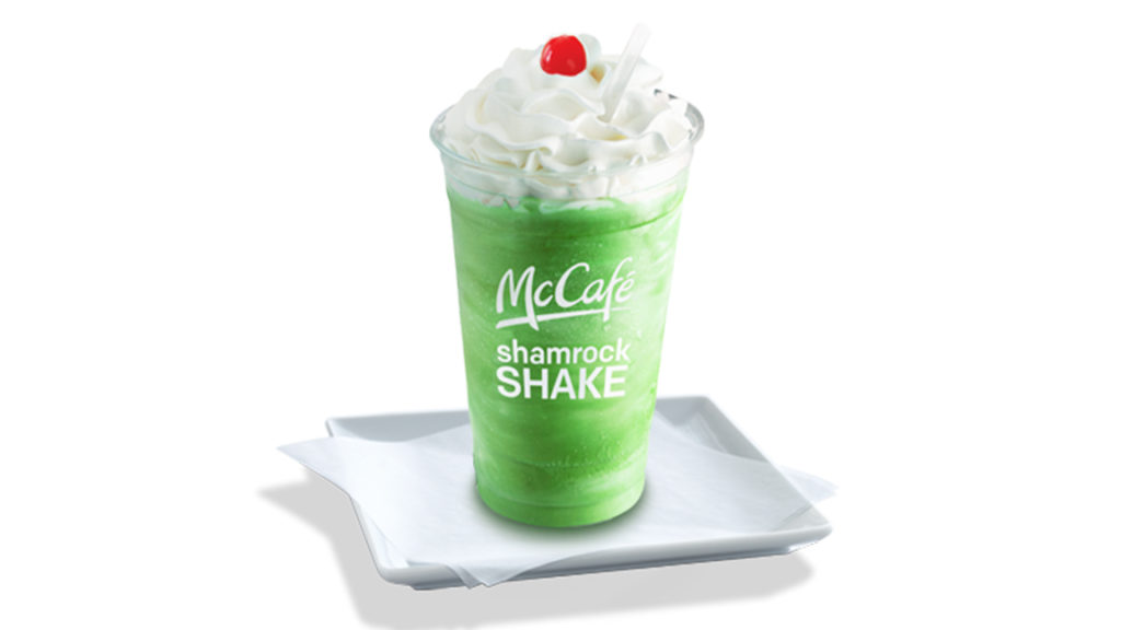 McCafe Shamrock Shake sitting on a glass dish