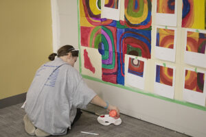 Ella Shaaw paints a section of the mural