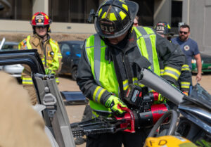 A firefighter works on removing a door during the Auto Extrication class at the 37th CITA-Kirkwood Fire School on Sept. 23-24, 2023.