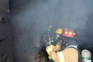 A instructor talks to a firefighter on how to attack a fire at the 37th CITA-Kirkwood Fire School on Sept. 23-24, 2023.