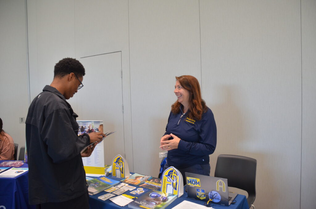 at the College Transfer Fair a student and admissions speaking