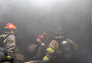 3 firefighter trying to put out a fire