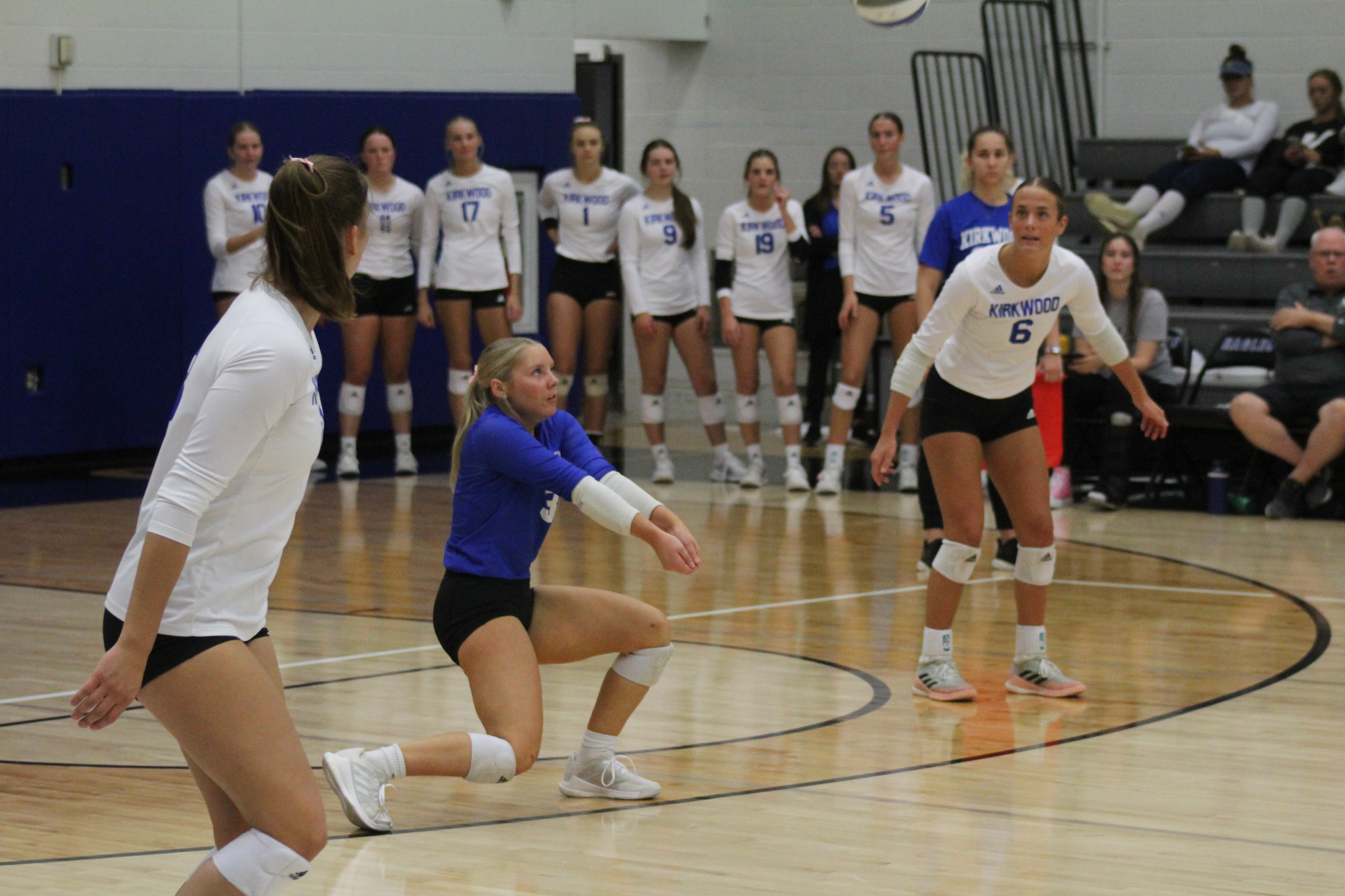 Lily Van Severen bumps the ball into air in volleyball match.