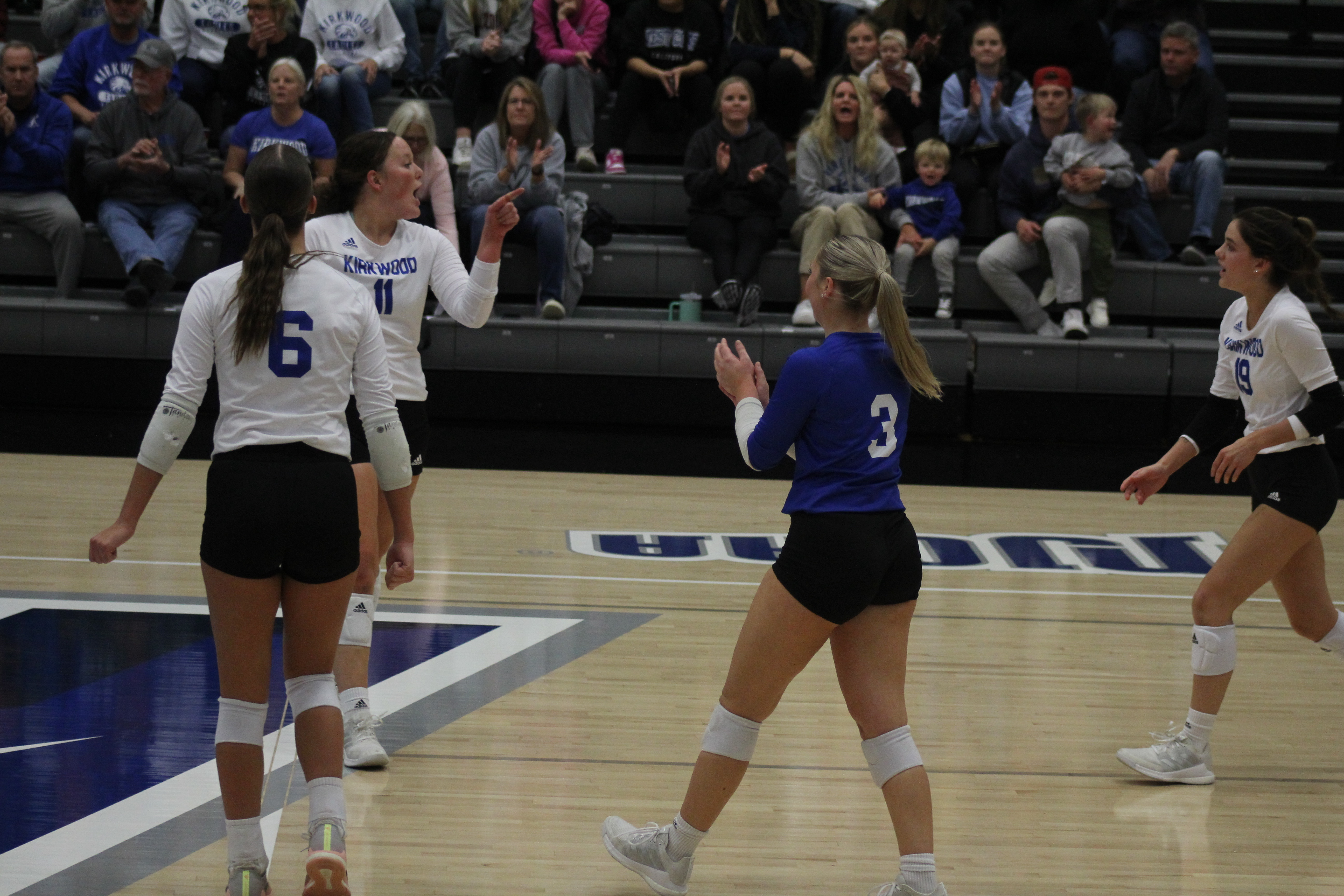 Sydney Matthias pointing at Maggie Lueck after a kill by Lexi Hearn on sophomore night against Hawkeye Community College.