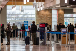Passengers wait in long lines to board their plane at the Cedar Rapids Airport.